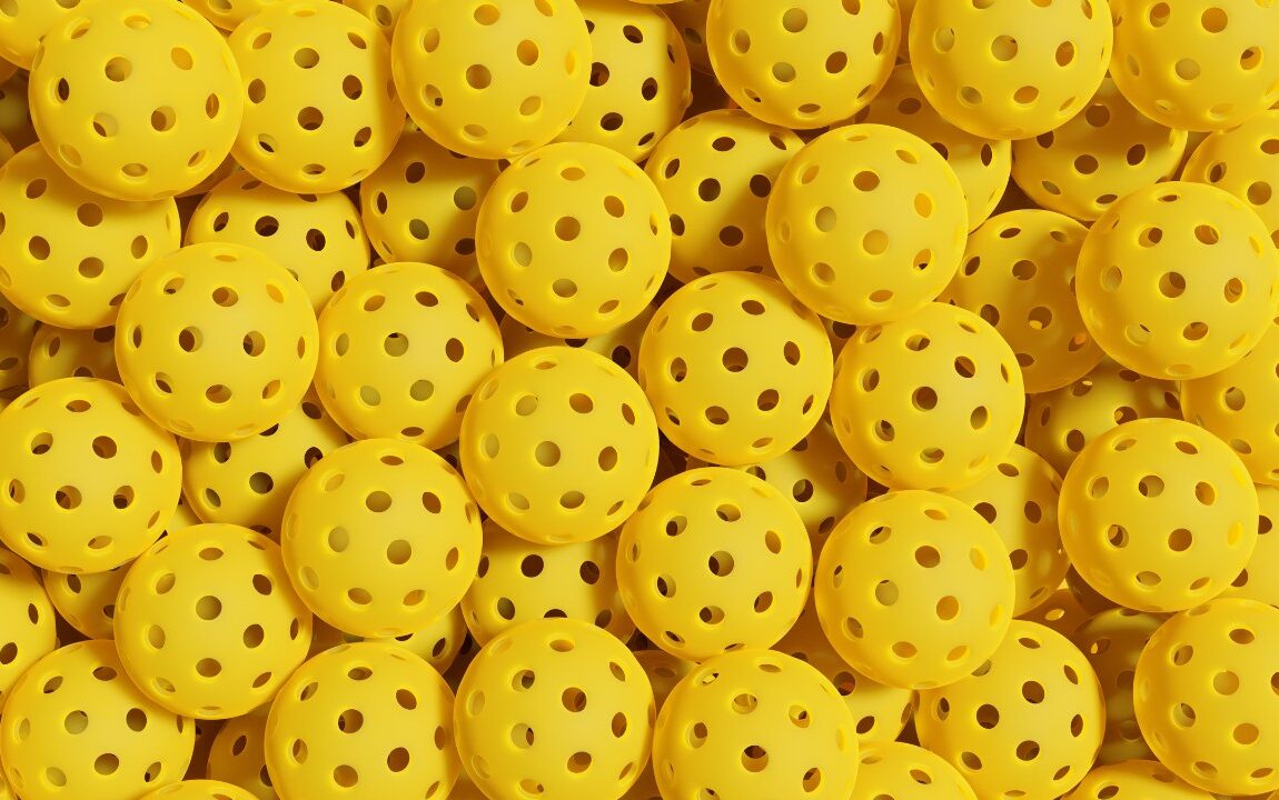 Stack of yellow pickleballs