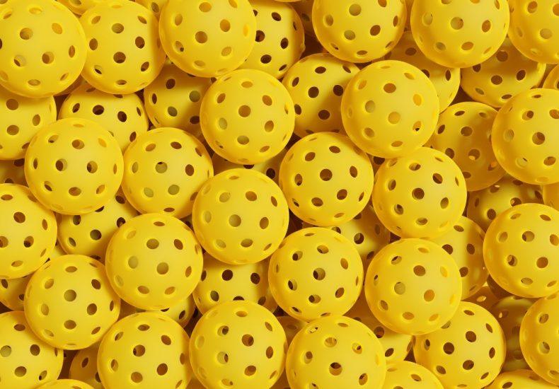 Stack of yellow pickleballs