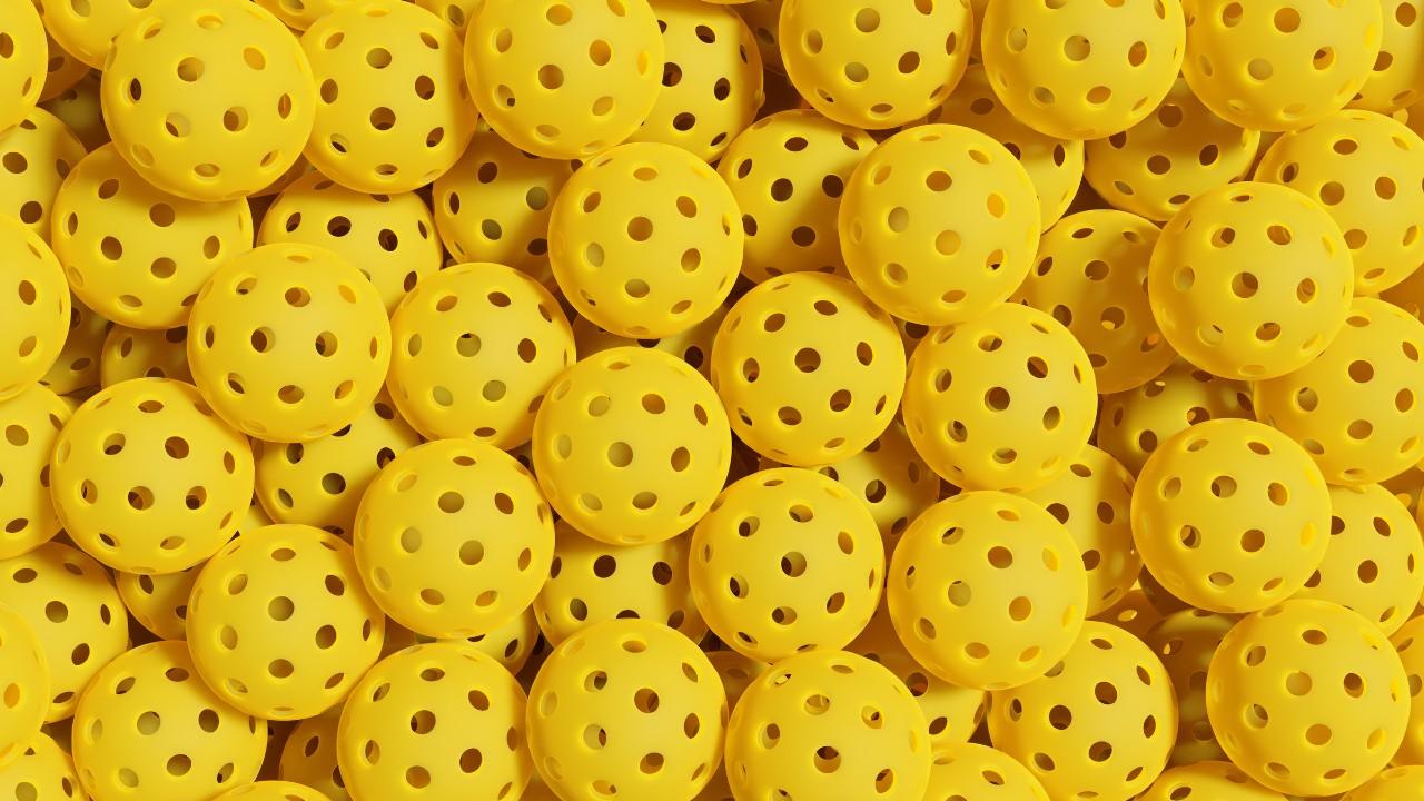 Stack of yellow pickleballs