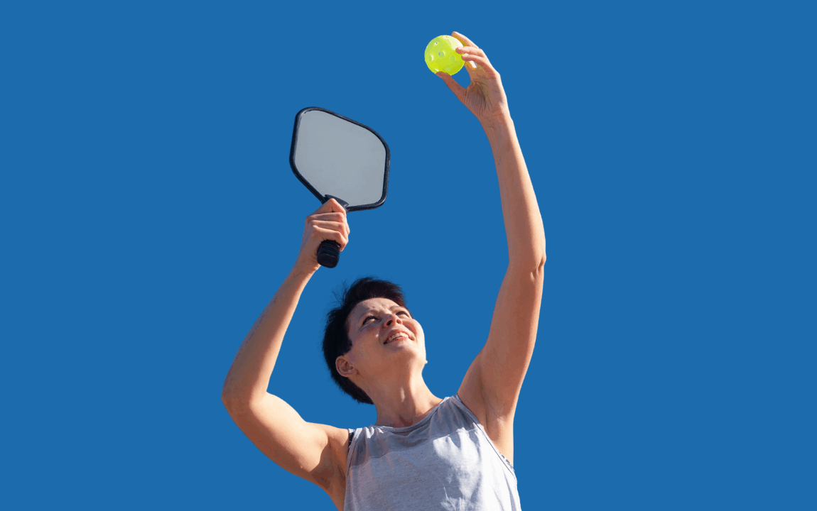 Woman player preparing to serve in a pickleball game