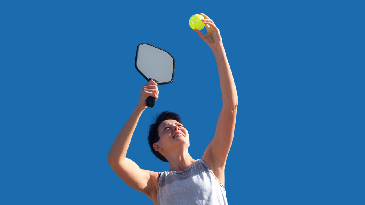Woman player preparing to serve in a pickleball game
