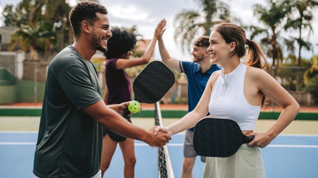 Players shake hands after a close pickleball game