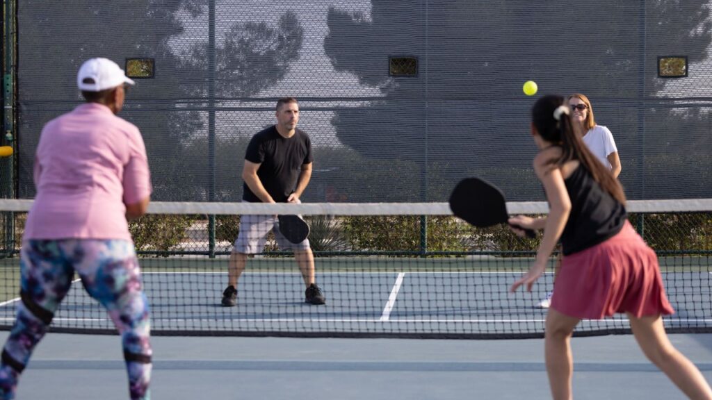 Intermediate-level players in a doubles pickleball game