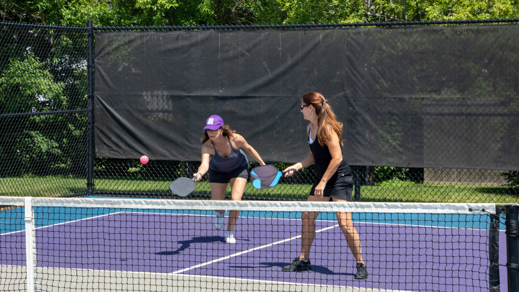 Two female players at the kitchen line during a pickleball doubles match