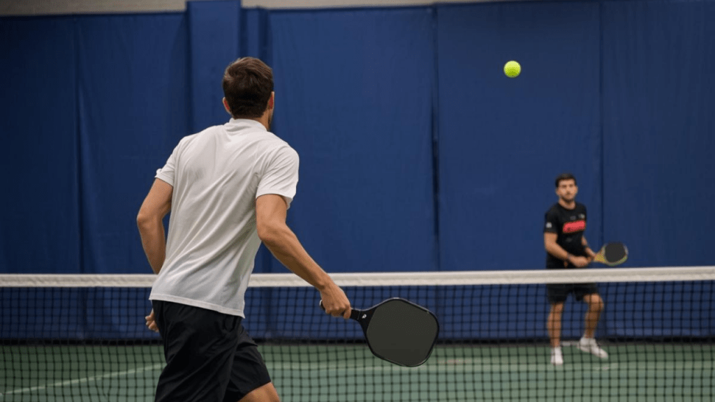 Pickleball players exchanging a fast rally near the net
