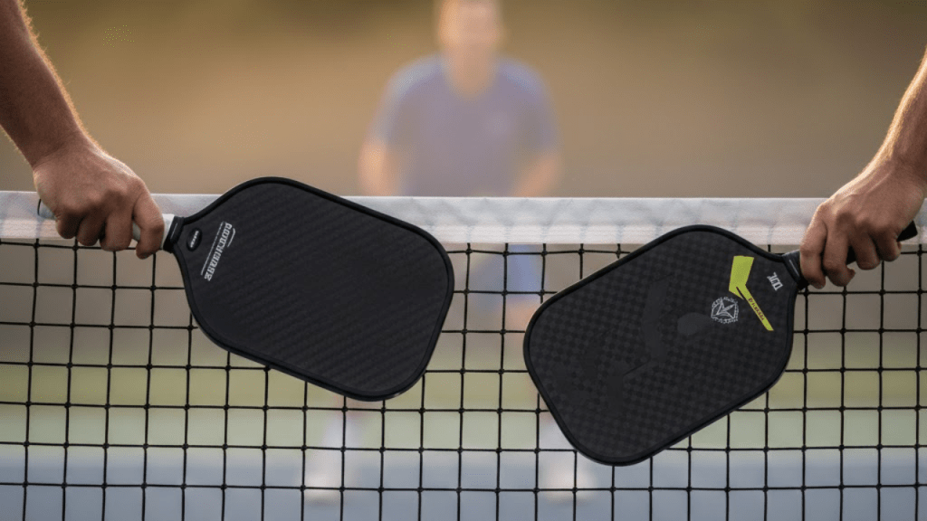 Pickleball player in ready stance at the net, preparing for a volley