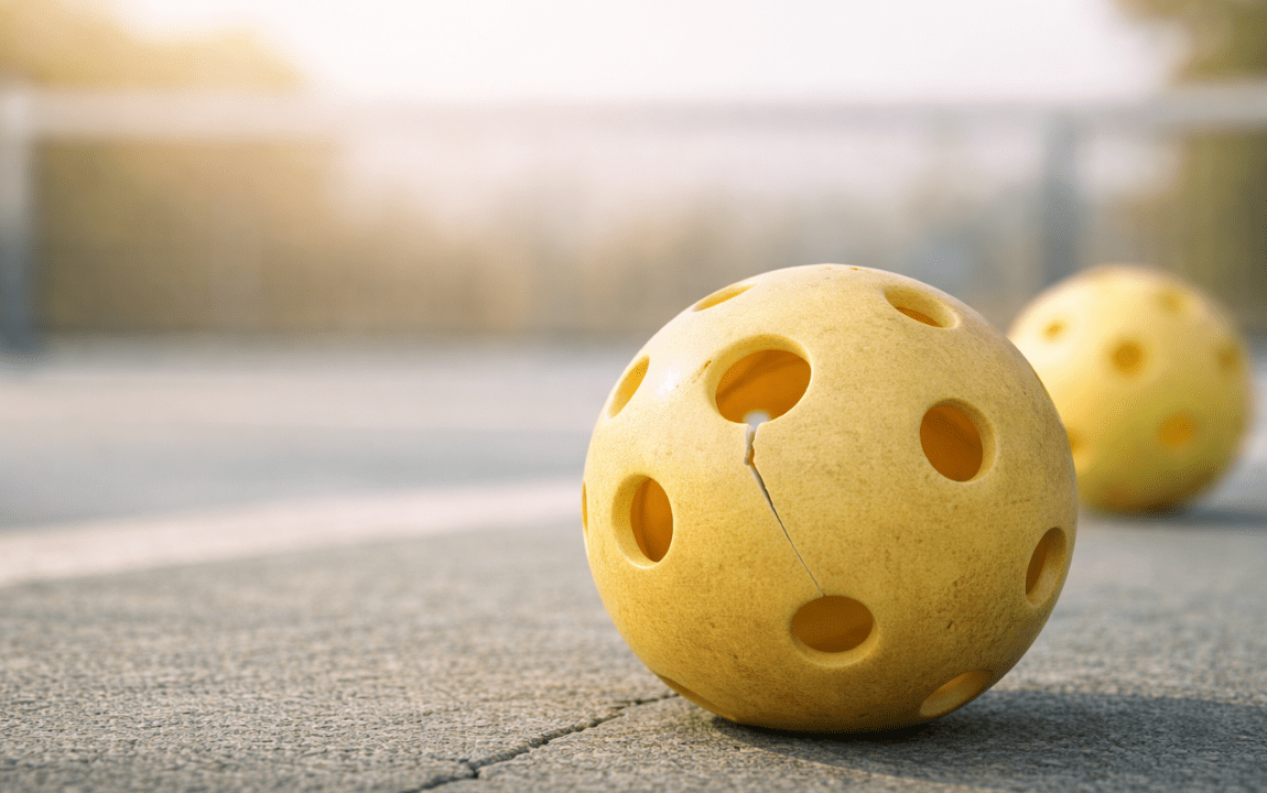 Cracked outdoor pickleball showing surface wear on the court